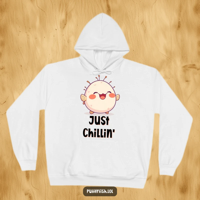 Funny hoodie featuring a chubby, round pufferfish bobbing with immense delight, radiating happiness and cozy vibes.